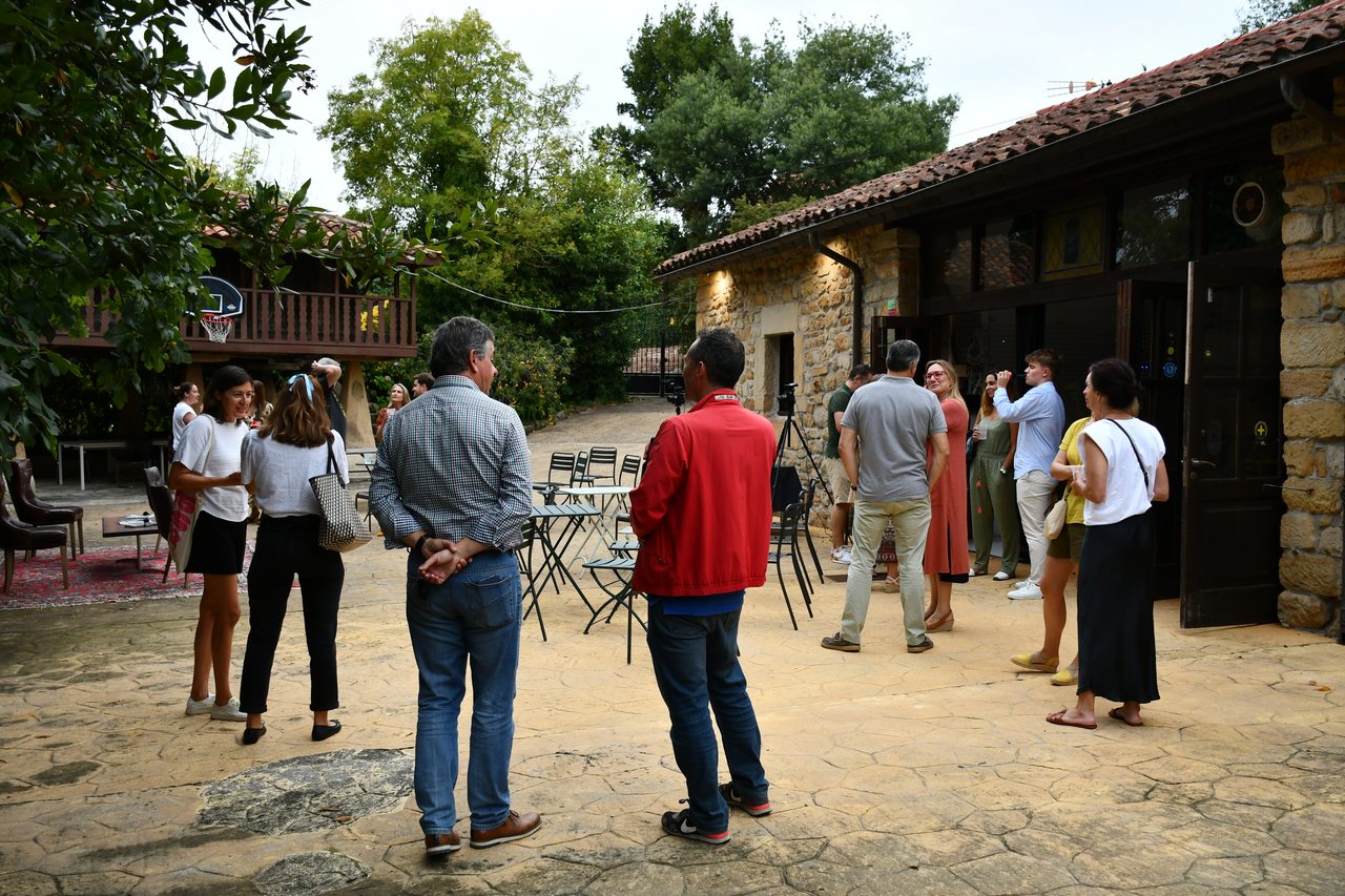 Participants arrive and talk in an outdoor courtyard at Diáspora