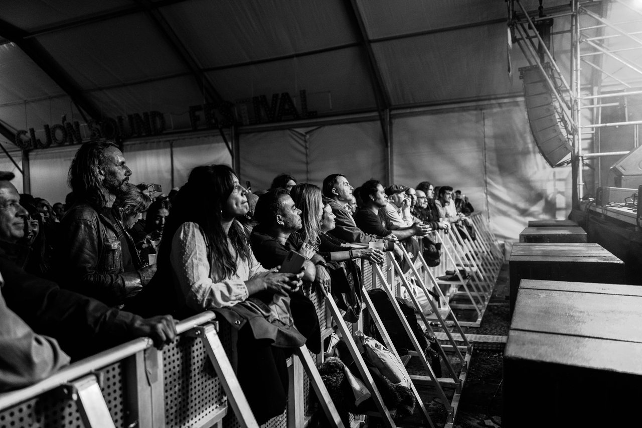 Concertgoers watch a performance from the front barrier at Gijón Sound Festival