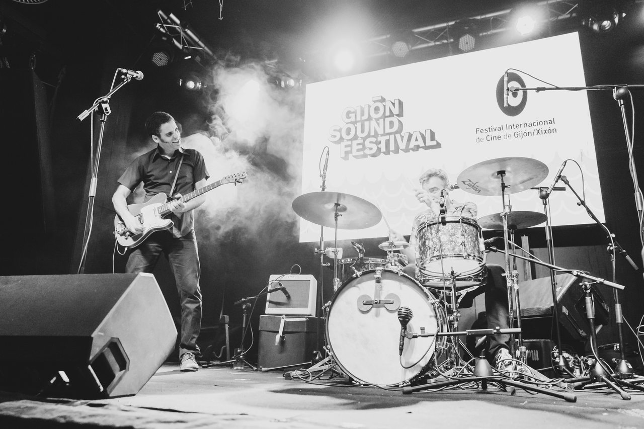 A live band performs on the Gijón Sound Festival stage in black and white