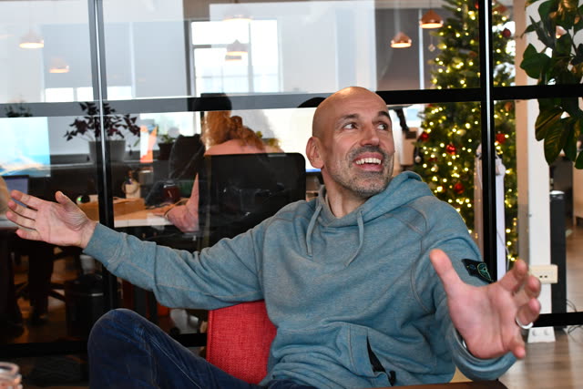 A man gestures during a conversation